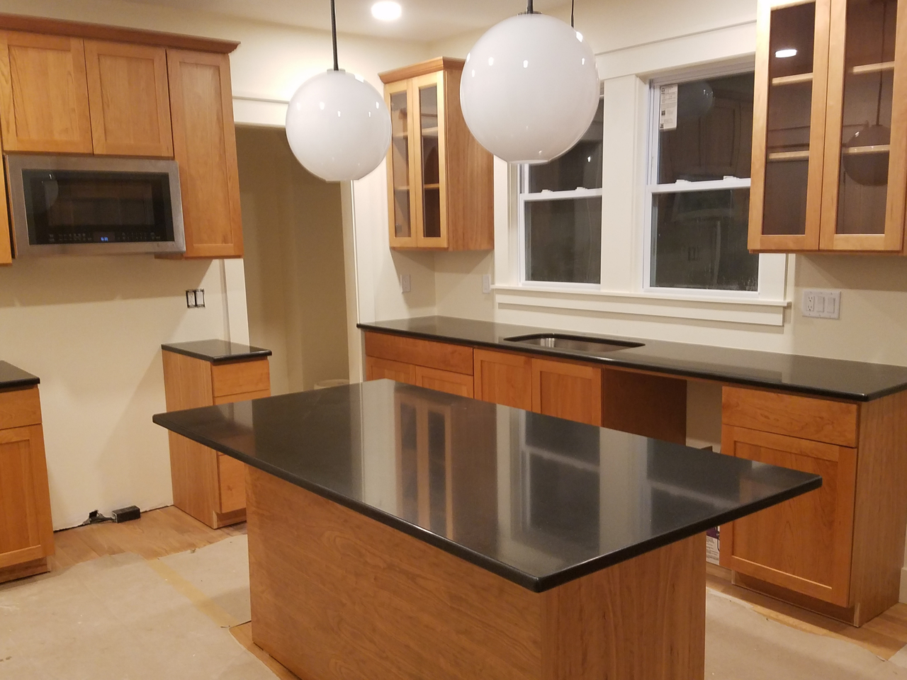 Cherrystone Furniture - Custom Kitchen Cabinets with Black Quartz Countertops